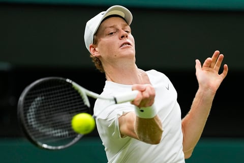 Jannik Sinner plays a forehand return to Daniil Medvedev